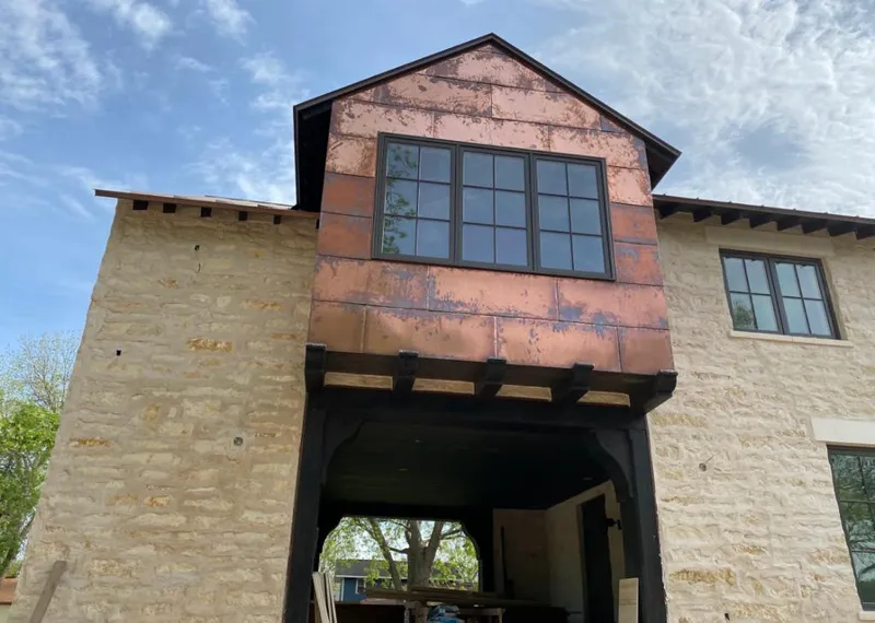 Copper metal panel facade on a stone building for Skylight Installation in Ketchikan