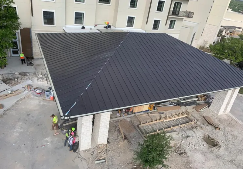 Metal roofing installation team working on a commercial building in Ketchikan