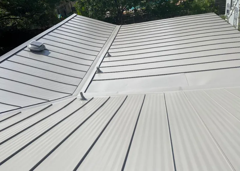 Solar attic fan installed on a metal roof for Roof Ventilation in Ketchikan
